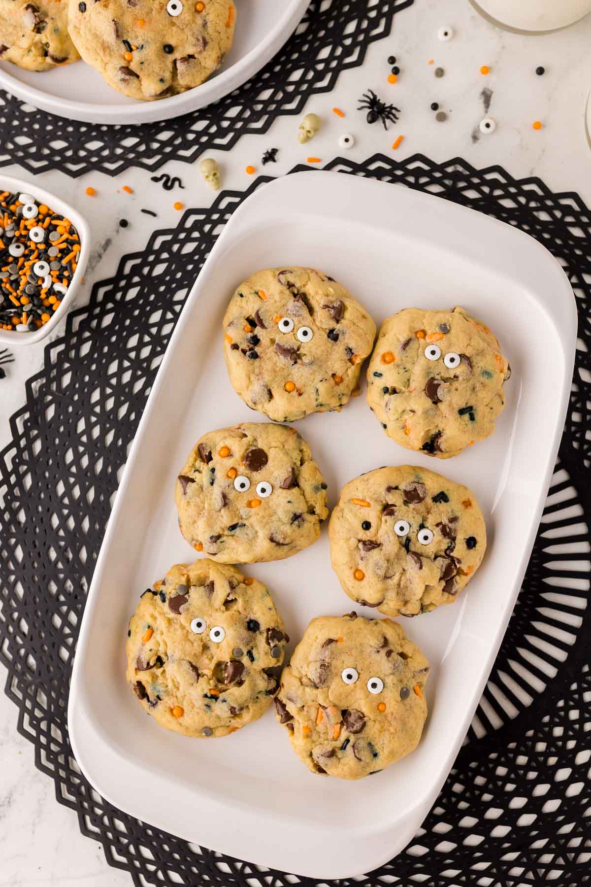 Halloween chocolate chip cookies with decorative candy eyes on a serving platter.