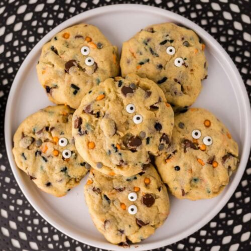 Overhead shot of Halloween chocolate chip cookies stacked on a plate.