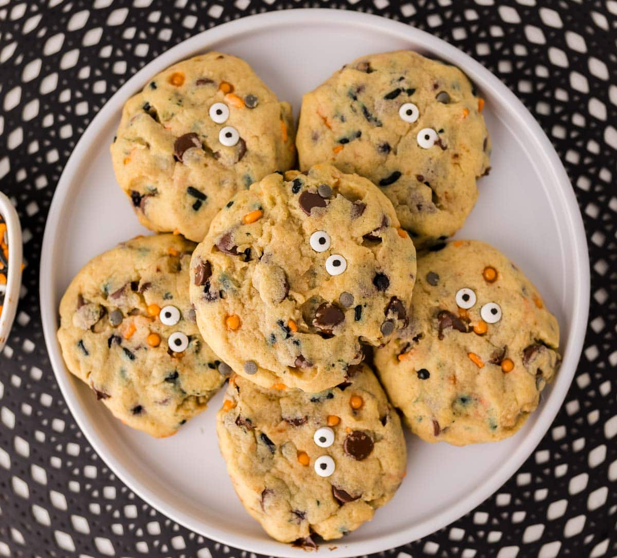 Overhead shot of Halloween chocolate chip cookies stacked on a plate.