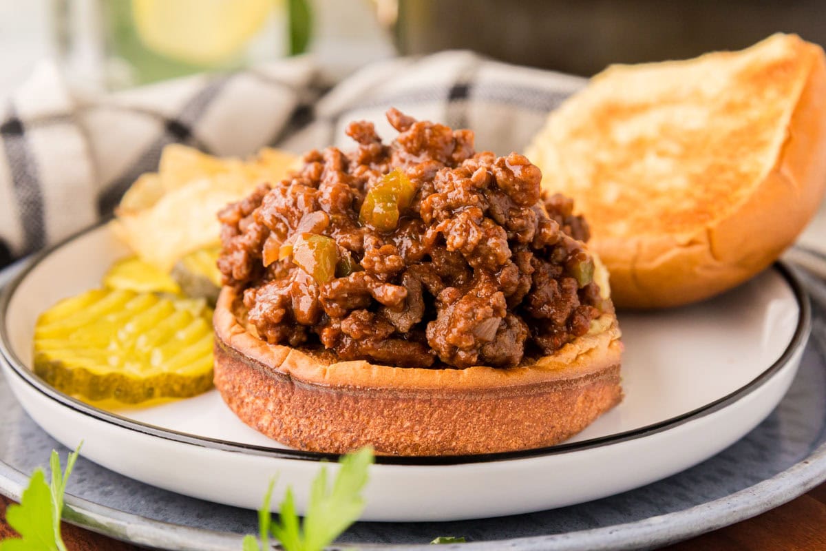 Sloppy Joe sauce on scooped onto the bottom of a hamburger bun.