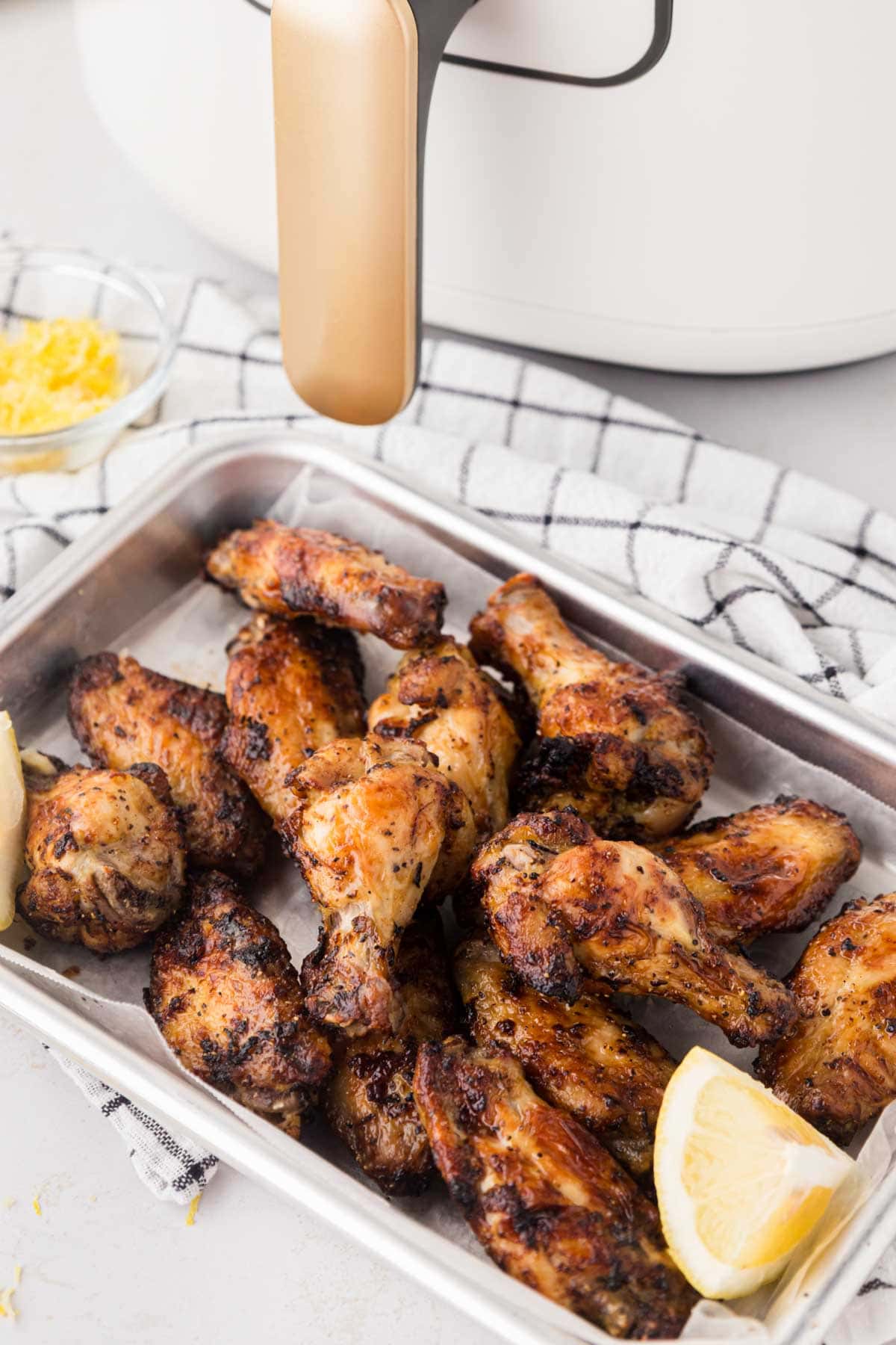 Lemon pepper chicken wings & drumettes on tray.