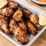 Lemon pepper wings on a serving tray.