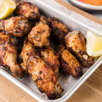 Lemon pepper wings on a serving tray.