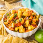 Close up of homemade peach salsa in a bowl.