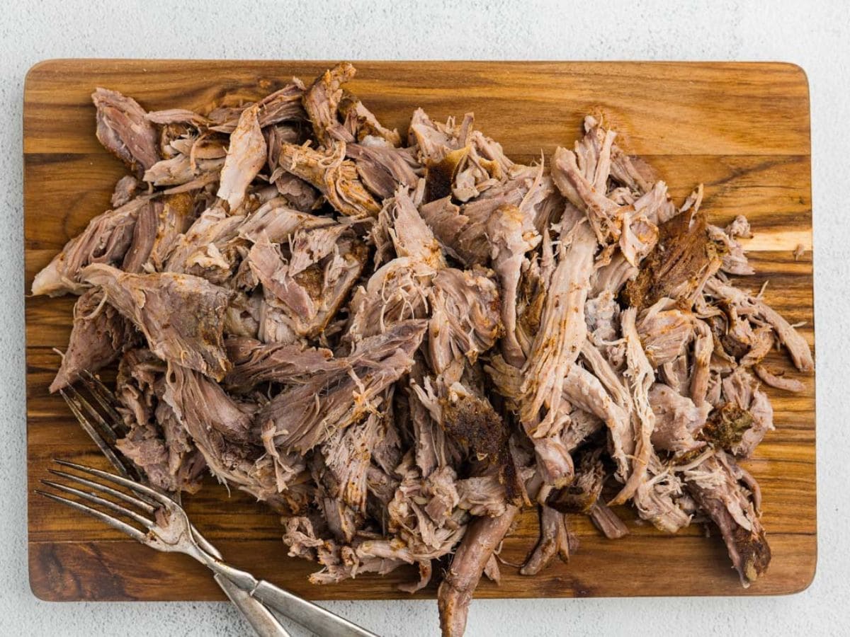 Pulled pork on a cutting board.