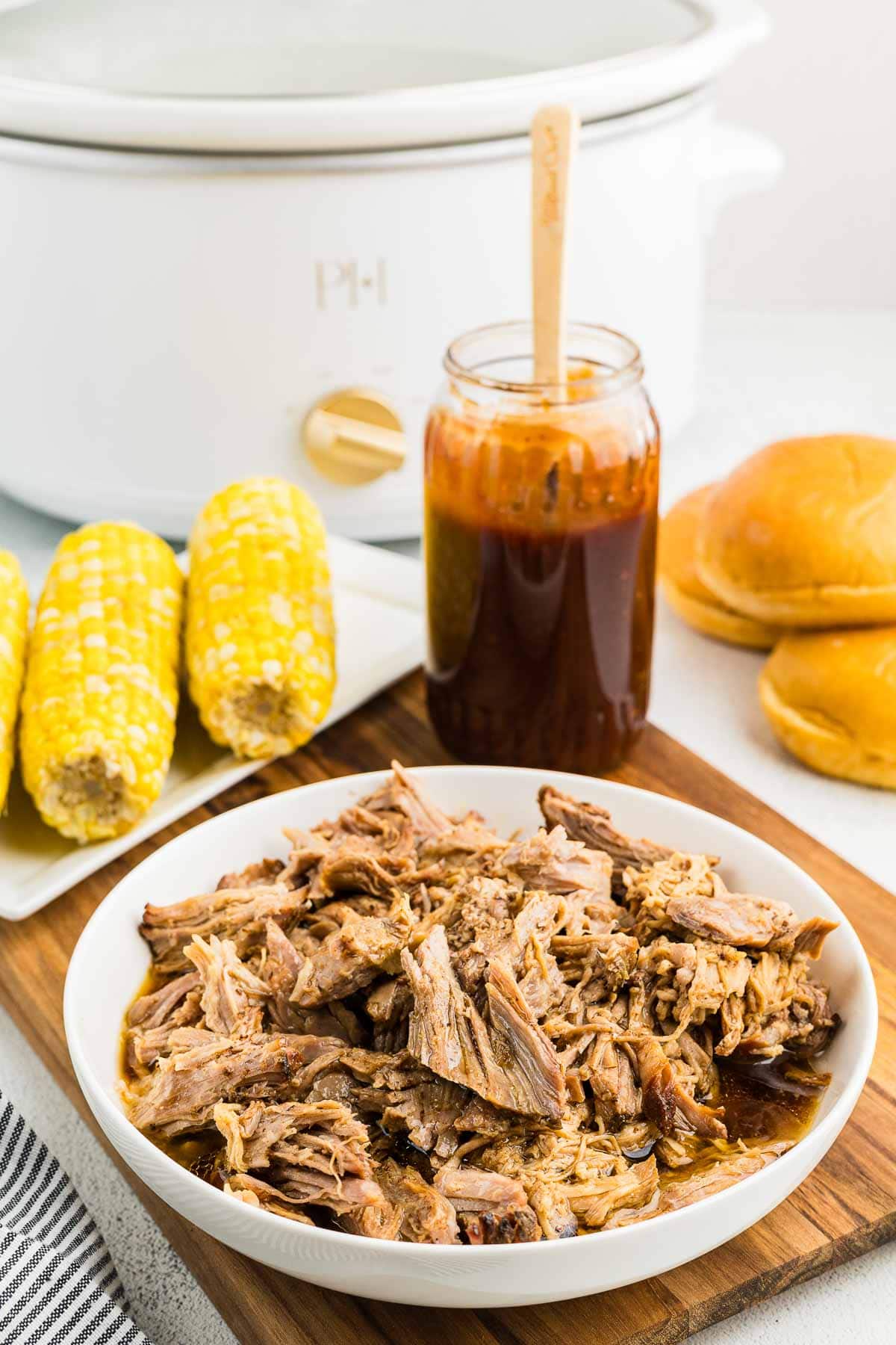 A white serving bowl with shredded pulled pork.