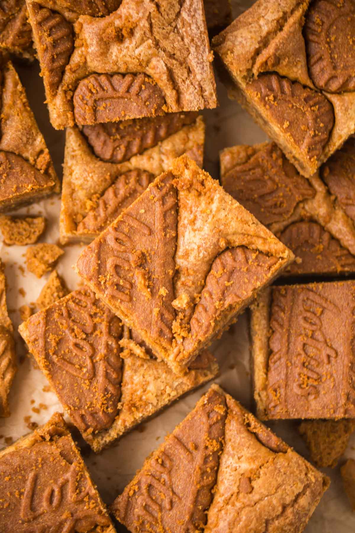 Overhead shot of biscoff blondies cut into squares and some stacked on top of others.