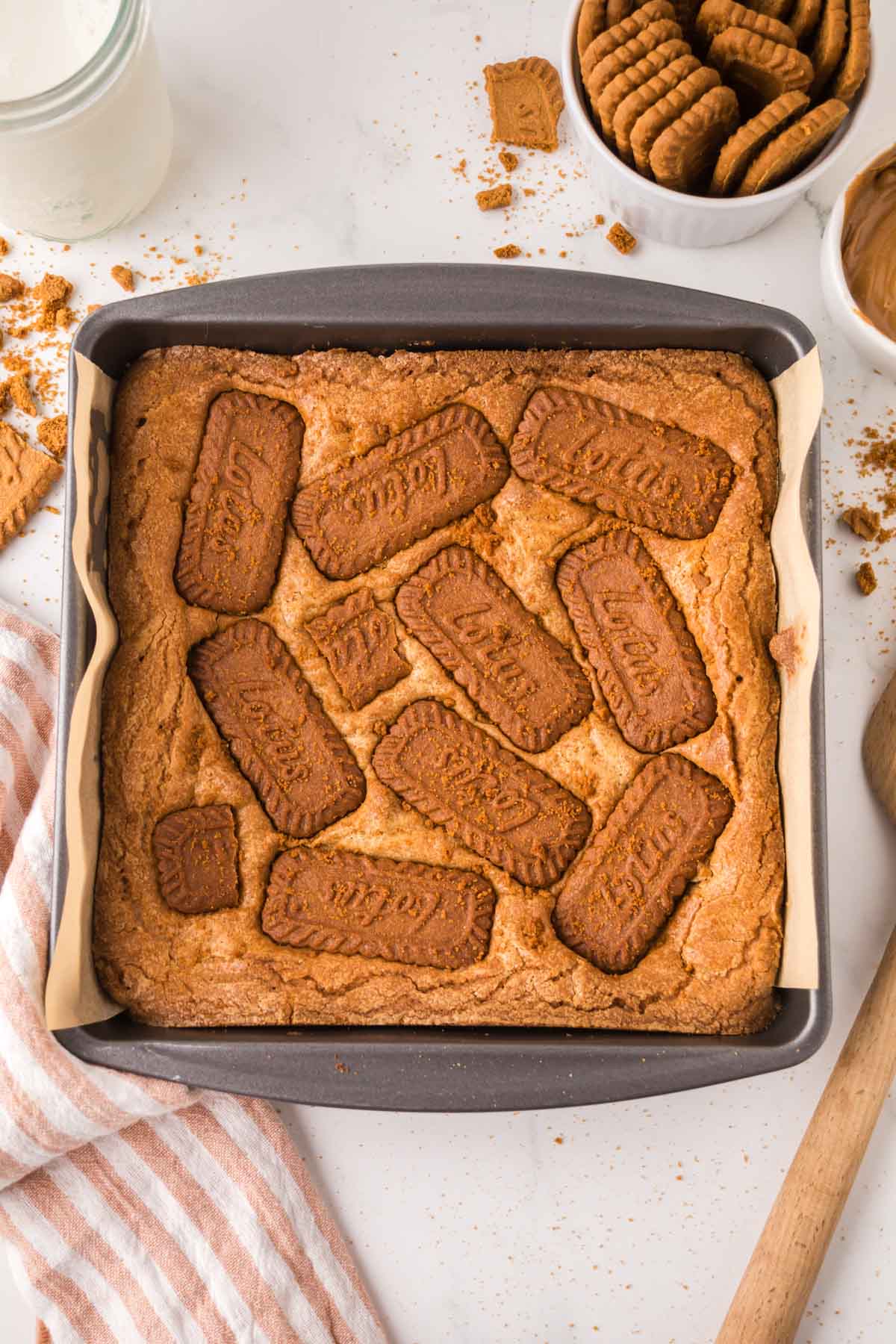 Overhead shot of biscoff blondies in a baking dish with biscoff cookies on top.