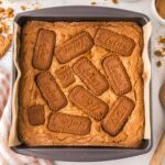 Biscoff blondies baked in a baking dish lined with parchment.
