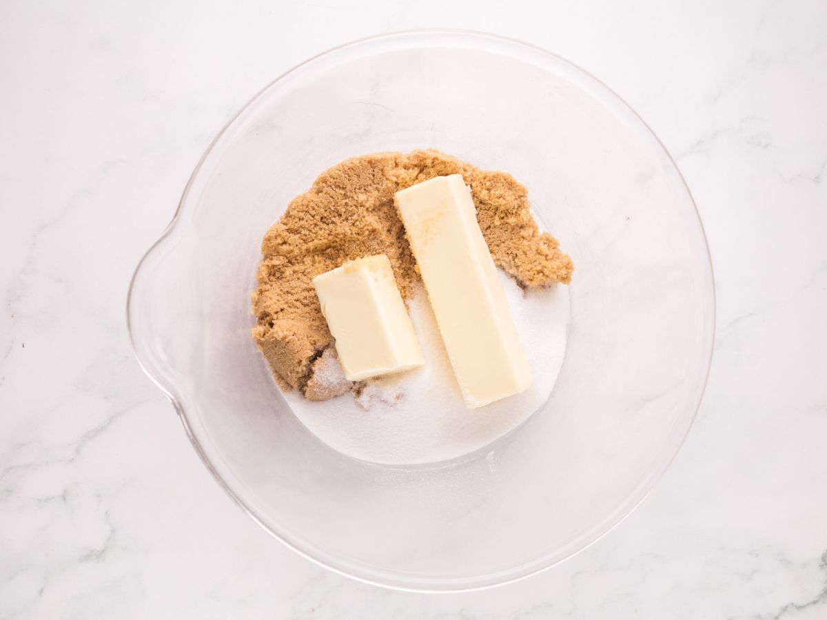 Butter, granulated sugar and brown sugar in a mixing bowl.