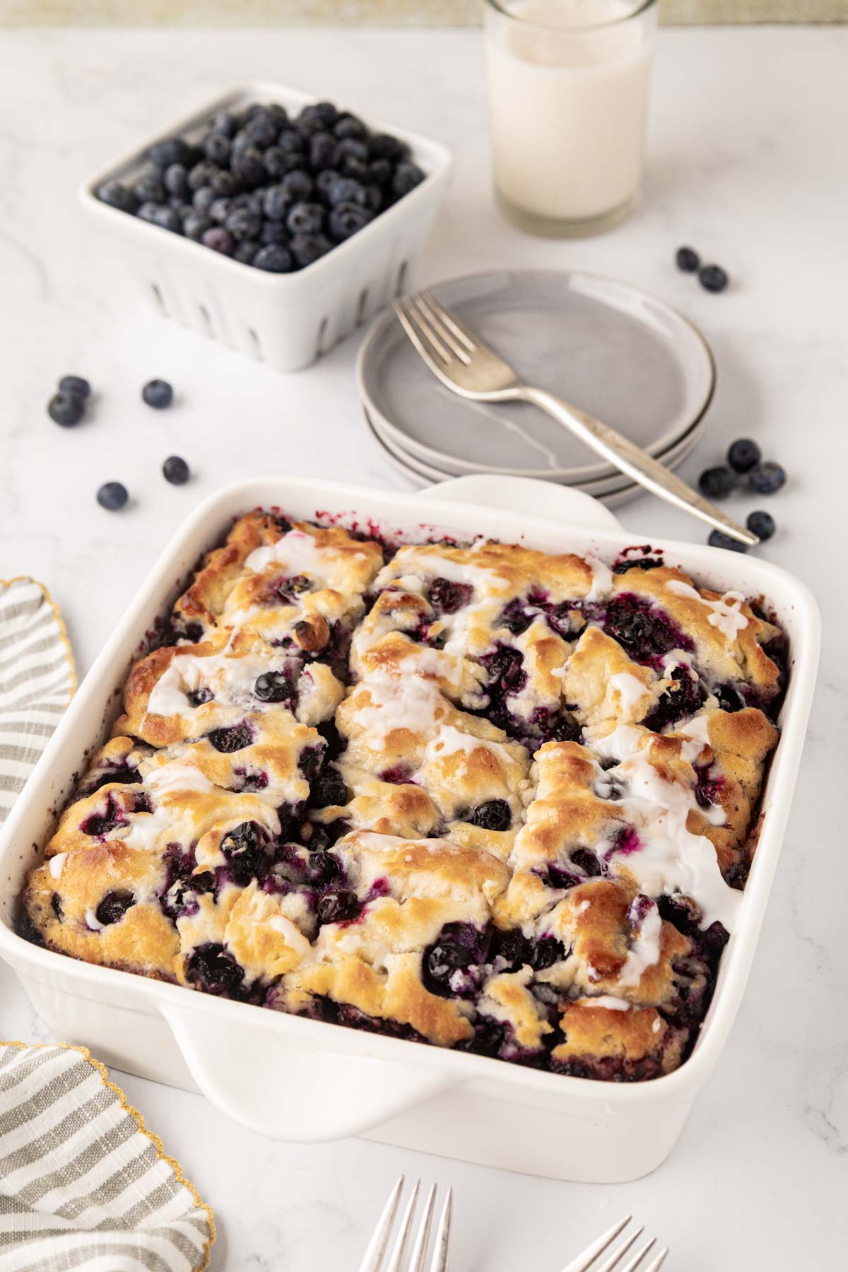Blueberry butter, swim biscuits in a white baking dish.