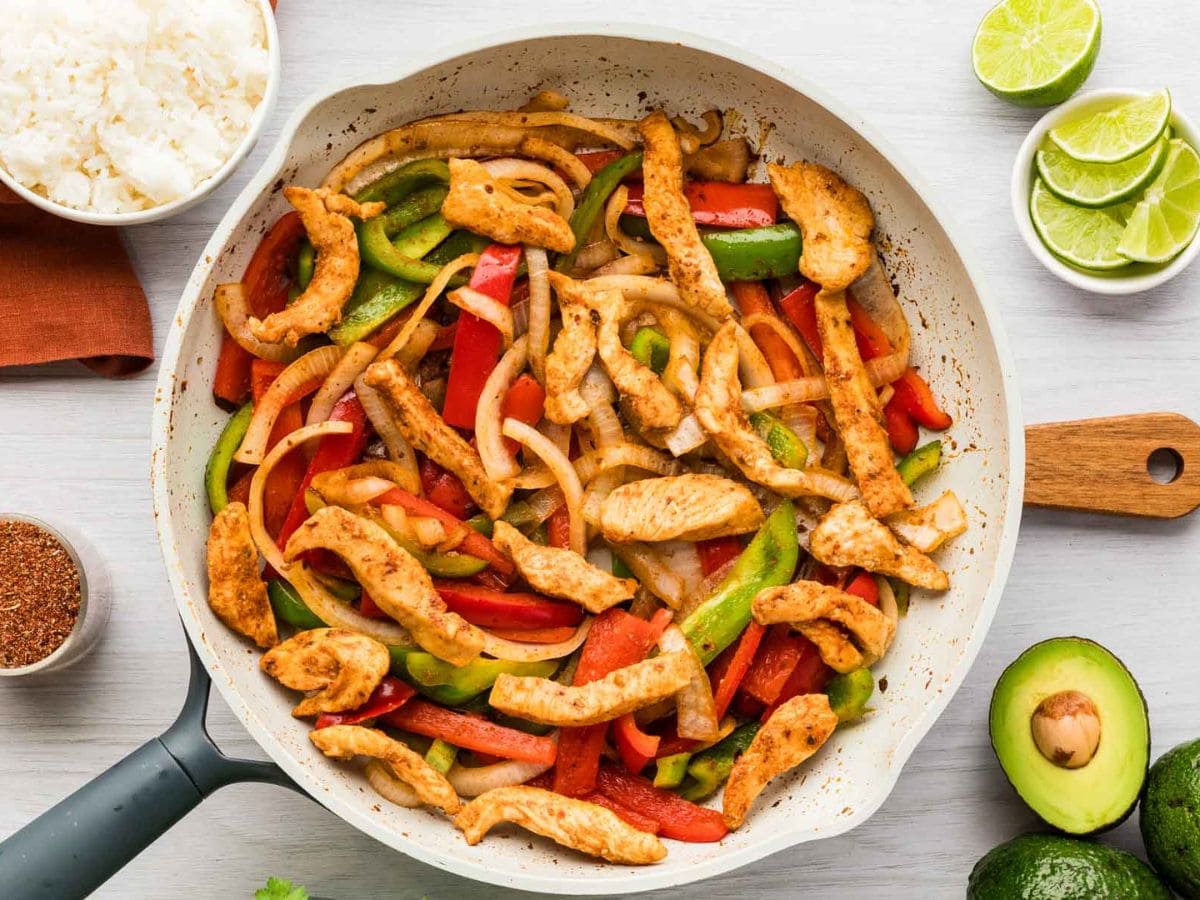 Chicken fajitas with veggies in a skillet.