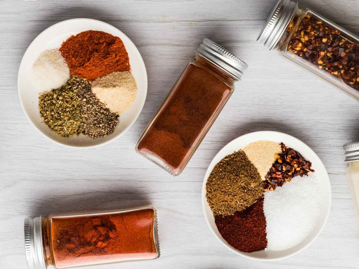 Seasonings measured out onto separate bowls for fajita seasoning.