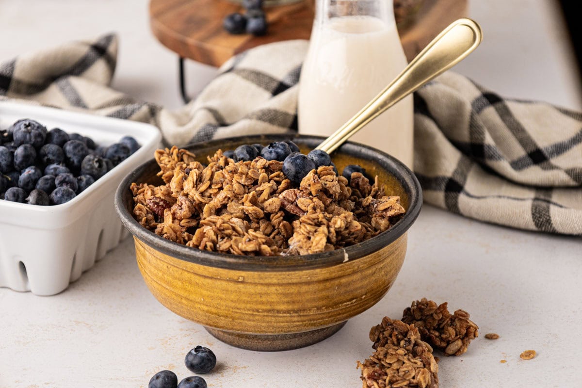 Pecan maple granola and a bowl with blueberries.