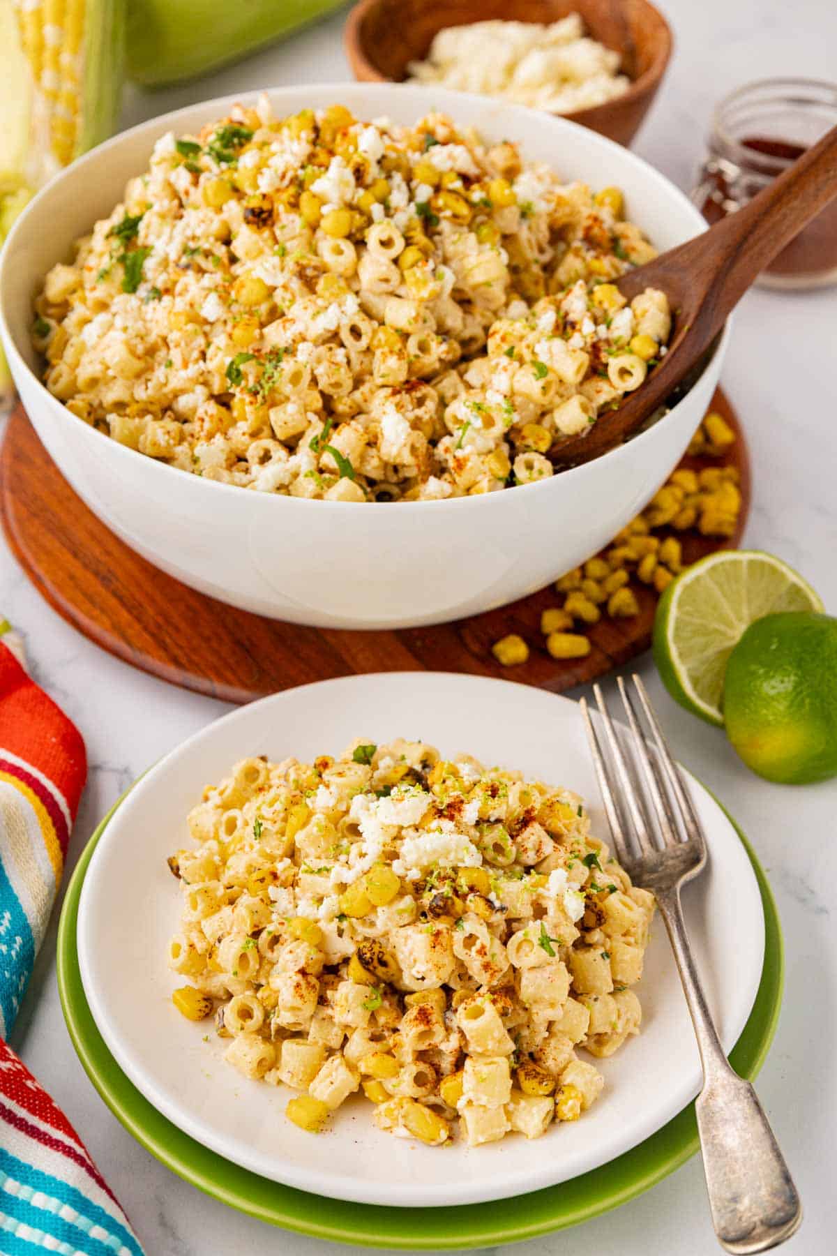 A serving of tex-mex pasta salad with a creamy elote dressing on a white plate.