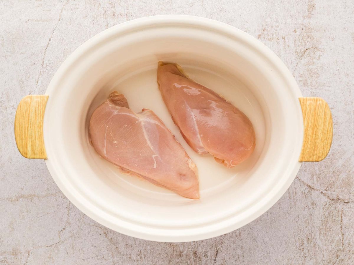 Chicken breasts in a slow cooker.