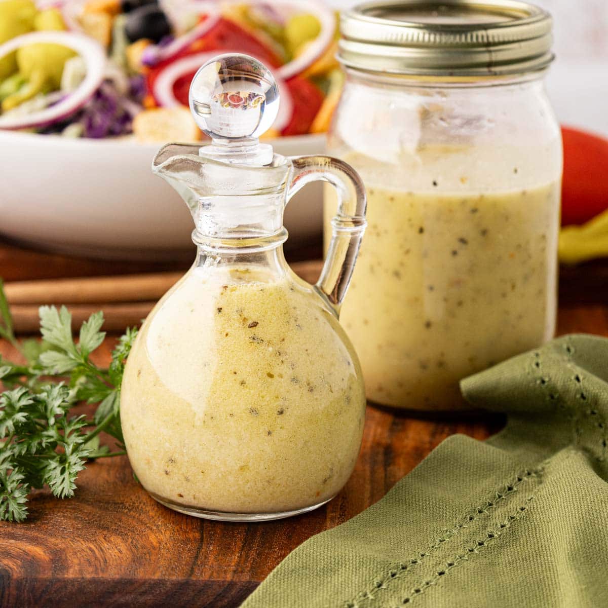 Homemade Copycat Olive Garden Salad dressing in a bottle and mason jar.