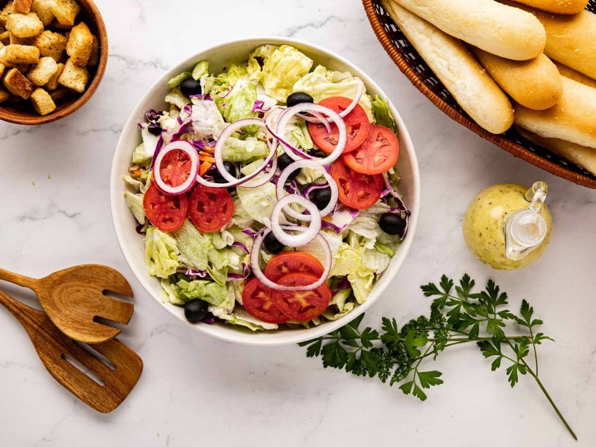 Salad blend tomatoes, black olives, and onions added a bowl.