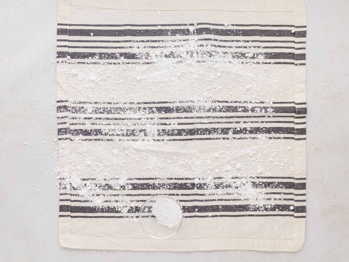 A tea towel dusted with powdered sugar.