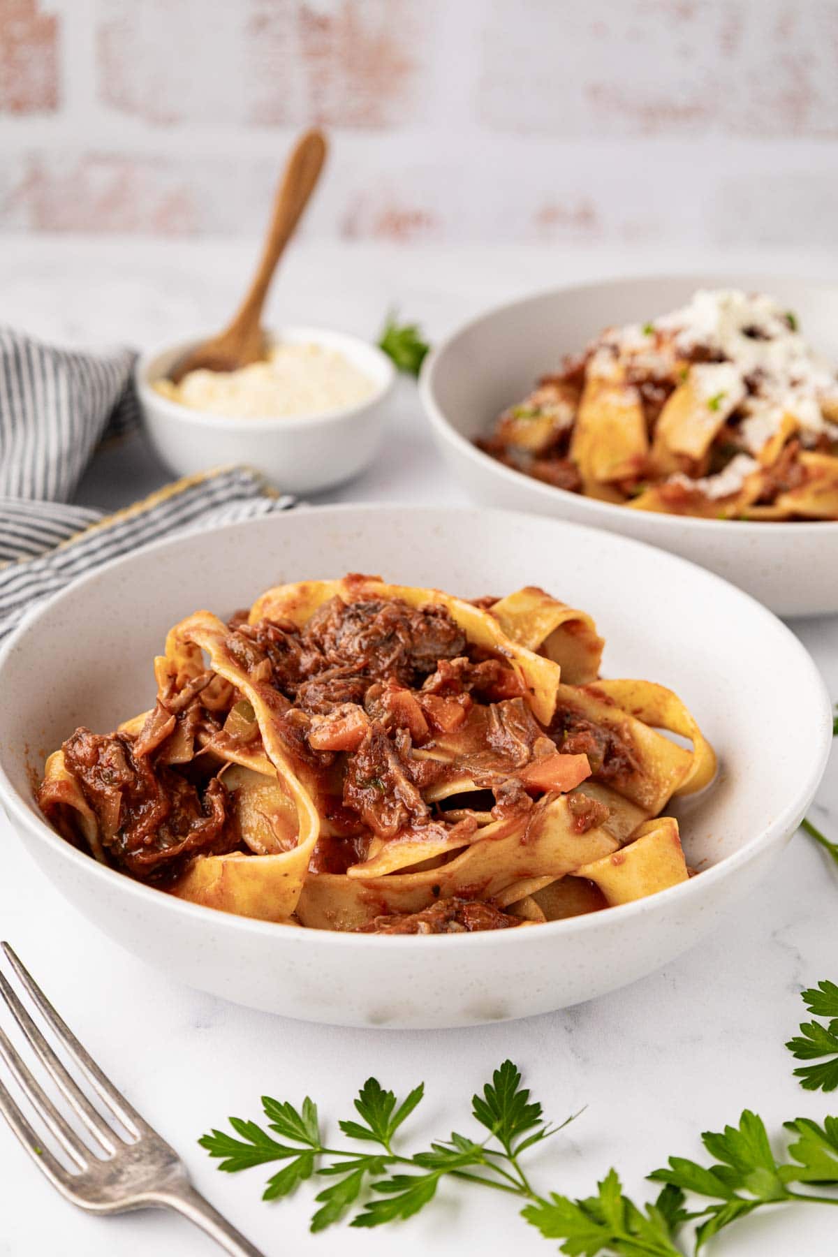 A serving of beef ragu world into Pappardelle pasta.