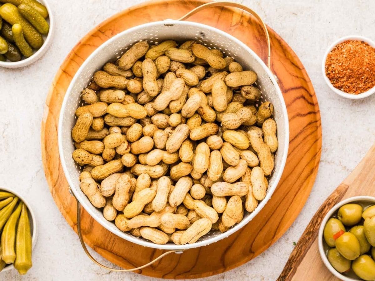 Drained washed raw green peanuts in a colander.