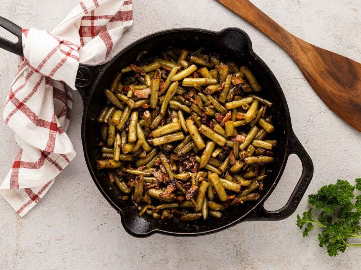 Finished crack green beans in a cast iron skillet.
