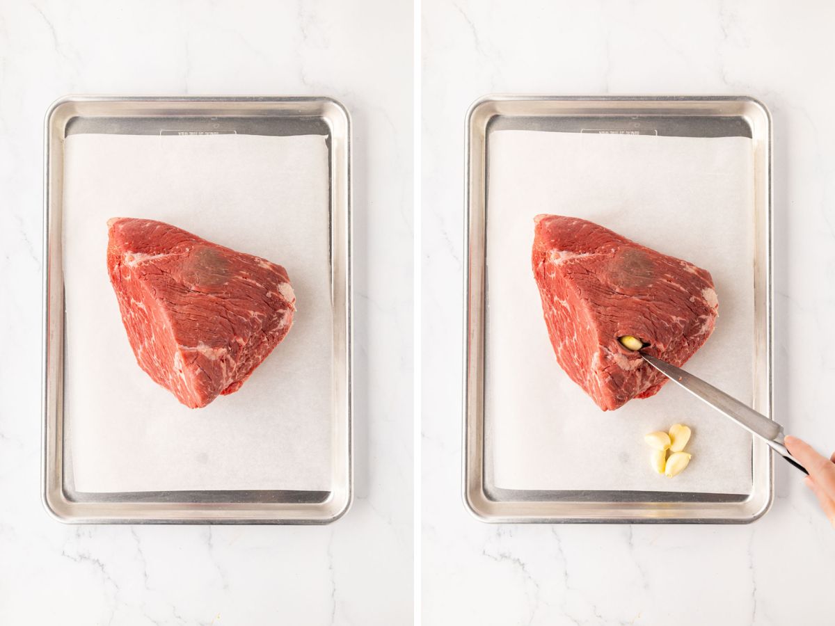 Using a knife to makes slits and add the garlic cloves to the rump roast.