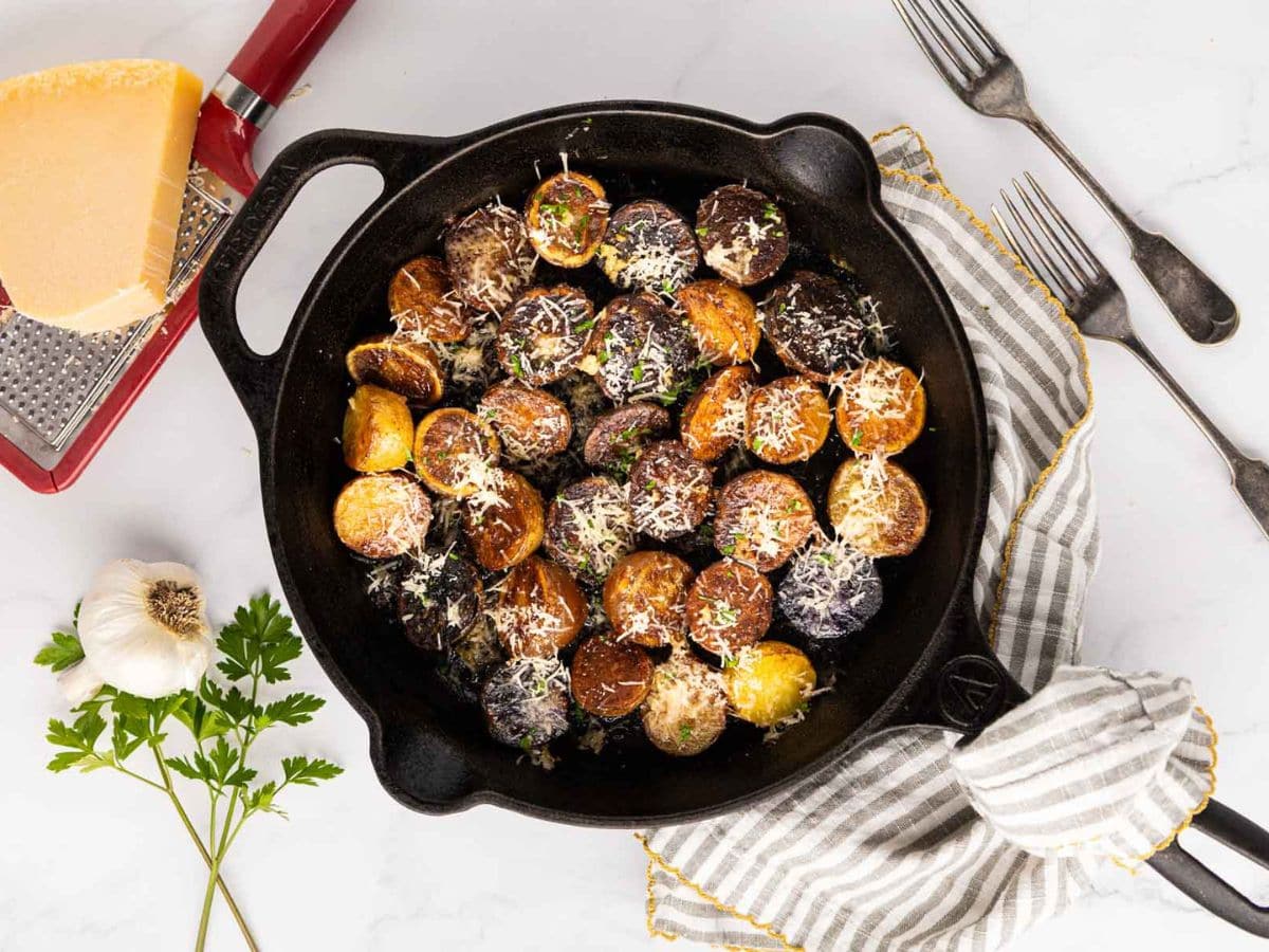 Garlic Parmesan potatoes after being cooked in cast iron skillet.