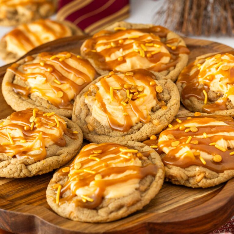 Harry Potter butterbeer cookies on a serving platter with frosting, caramel sauce and sprinkles on top.