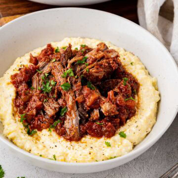 Stracotto Italian pot roast served on a bed of polenta.
