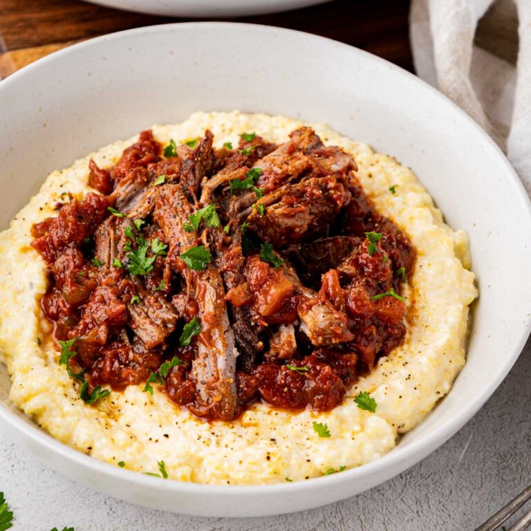 Stracotto Italian pot roast served on a bed of polenta.