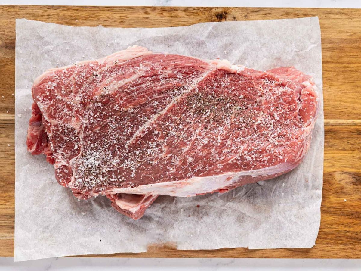 Chuck roast seasoned with salt and pepper.
