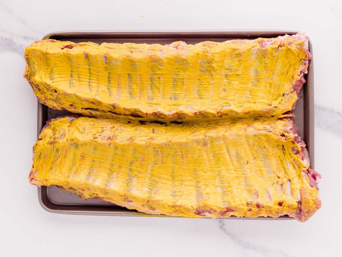 Yellow mustard coating the ribs.