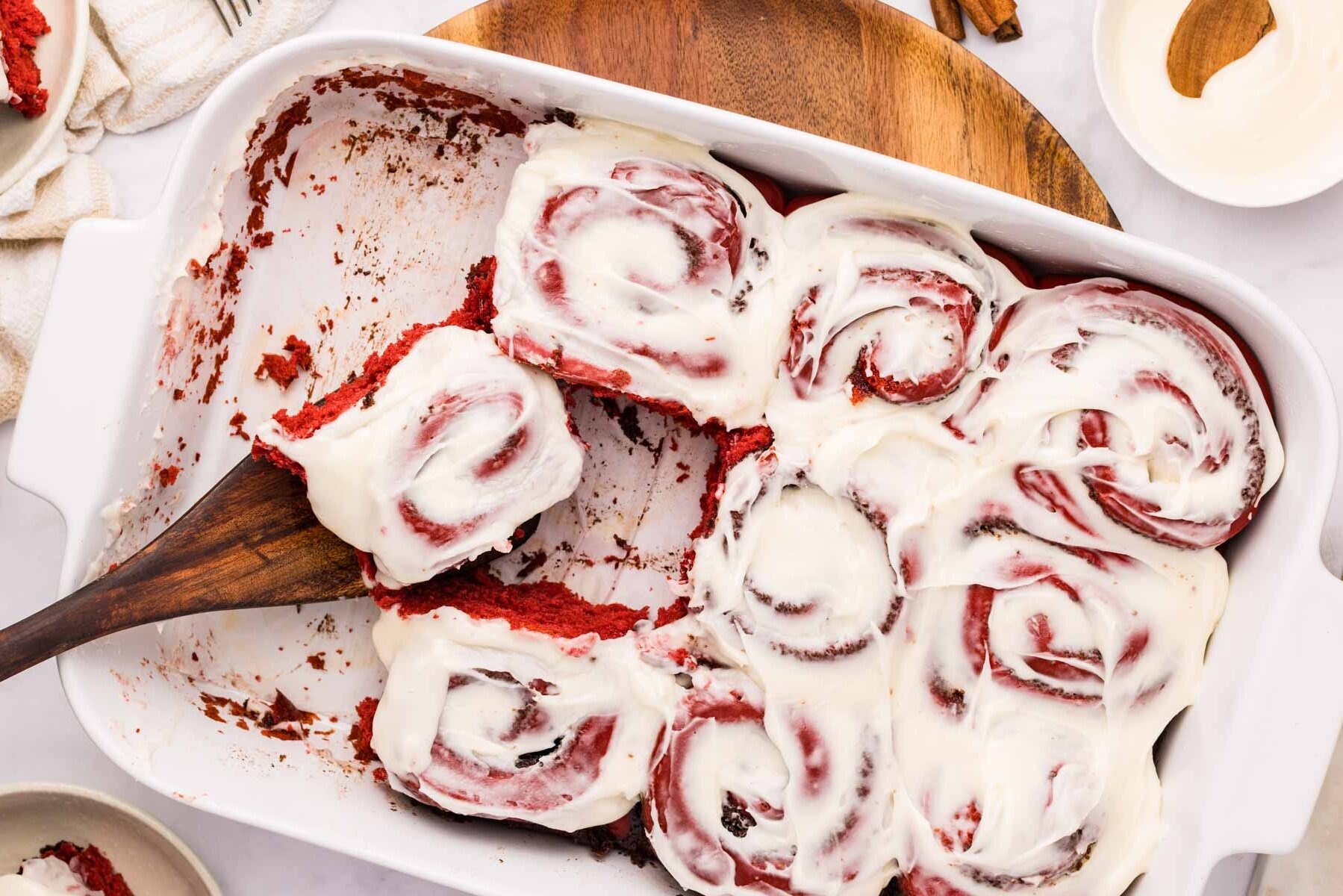 A pan of gooey red velvet cake mix cinnamon rolls.