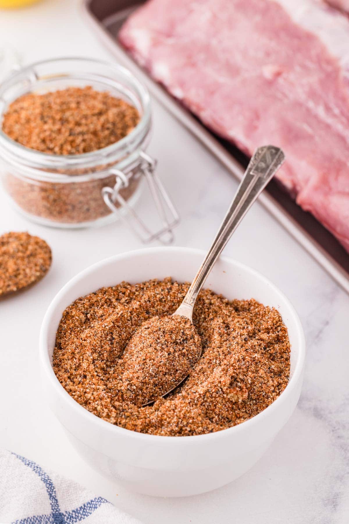 Rib rub with a rack of ribs in the background.