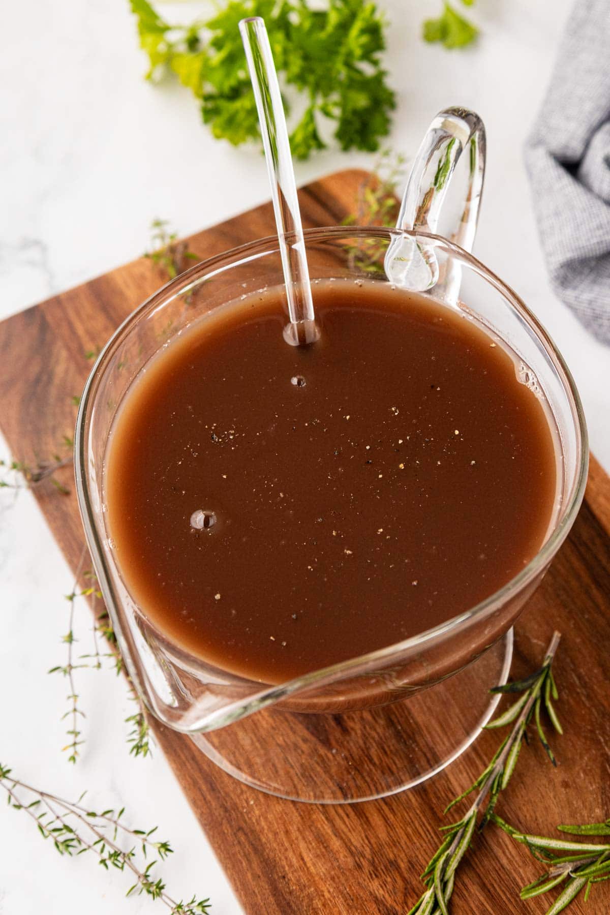 Au jus in a clear glass bowl.