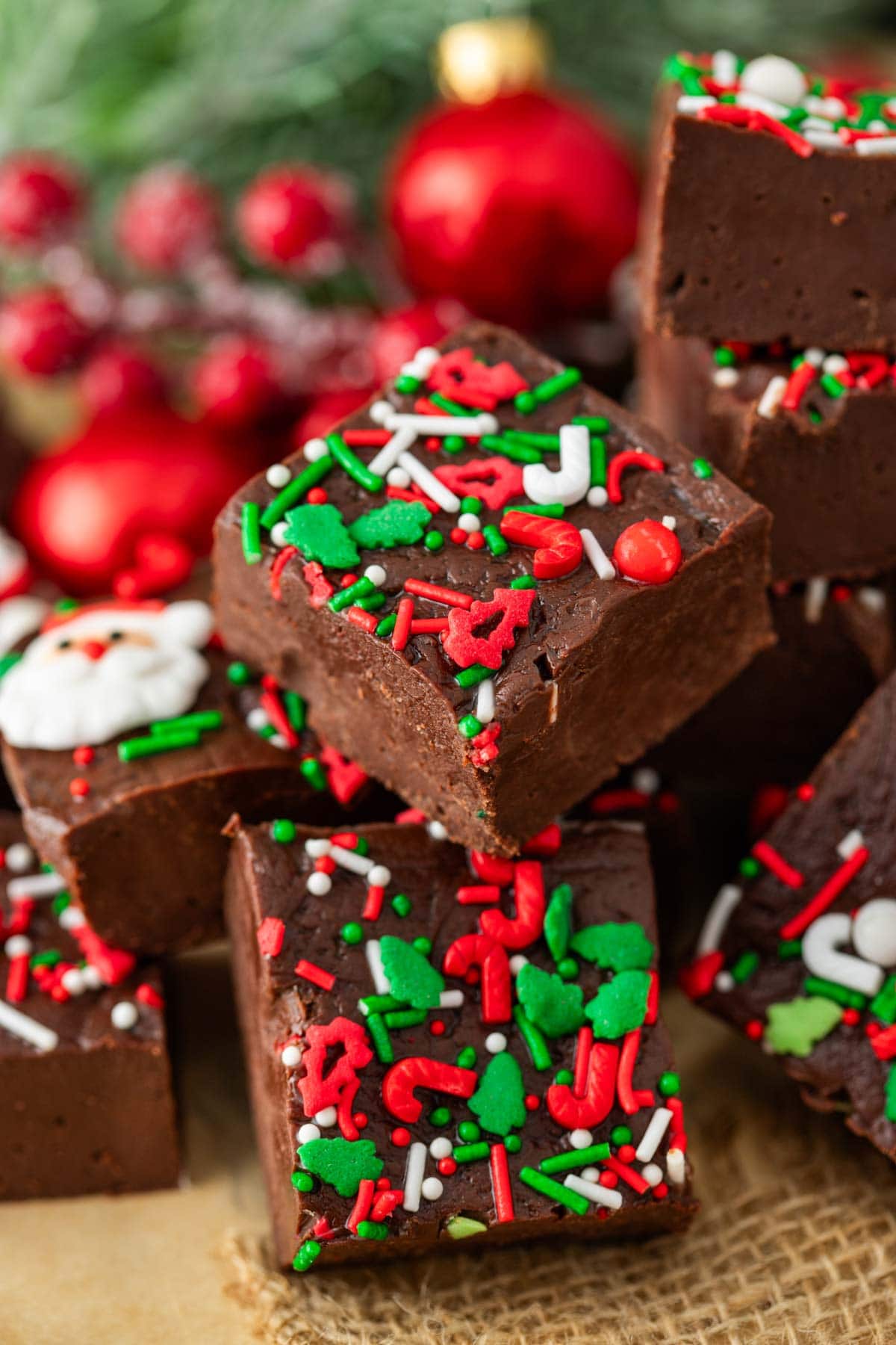 Square pieces of Christmas fudge stacked on top of each other.