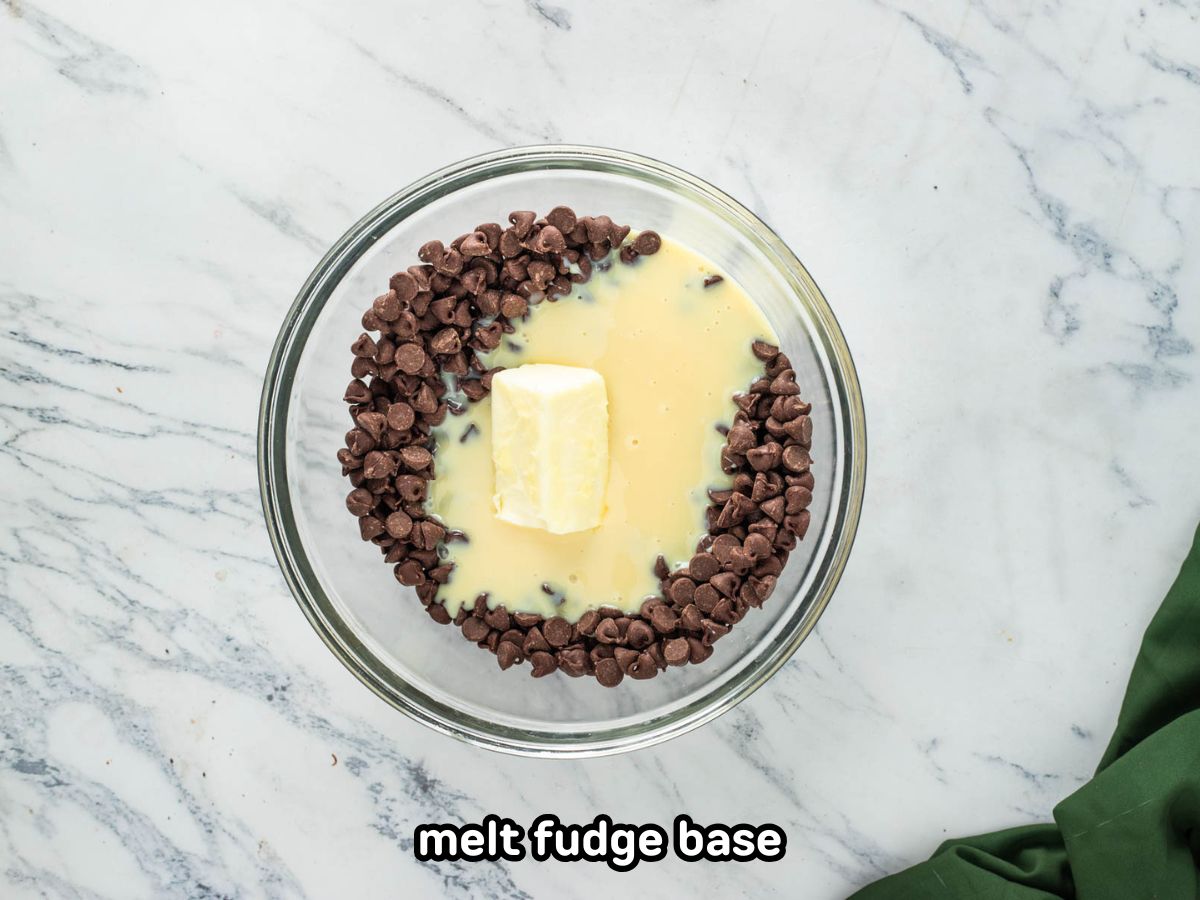 Adding melted butter to a bowl of chocolate chips.