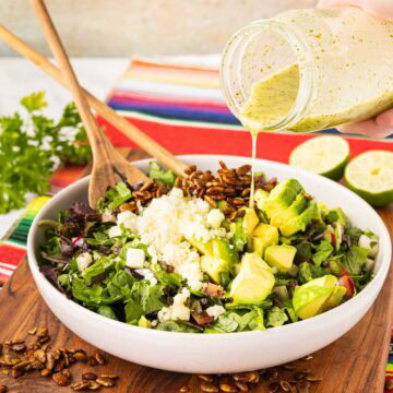 ouring cilantro, lime vinaigrette on the Mexican, chopped salad, topped with cheese, avocado, and spiced pepitos.