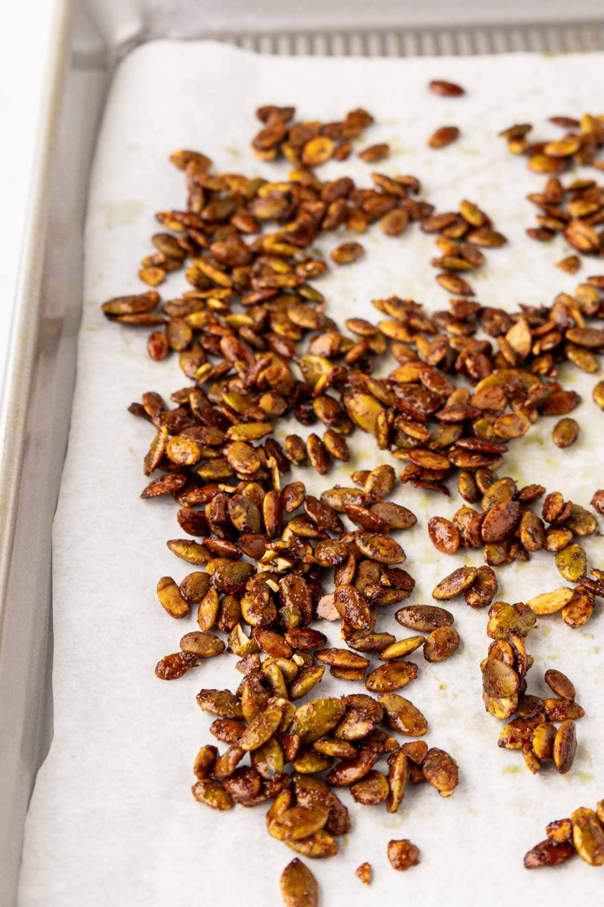 Roasted spicy pepitas on a baking tray.