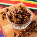 Roasted pumpkin seed in a glass bowl.