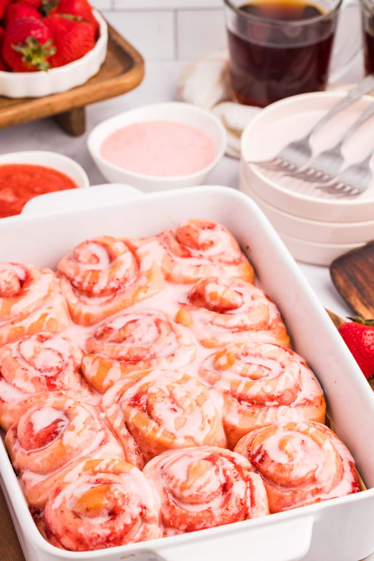 Strawberry cinnamon rolls in a baking dish.