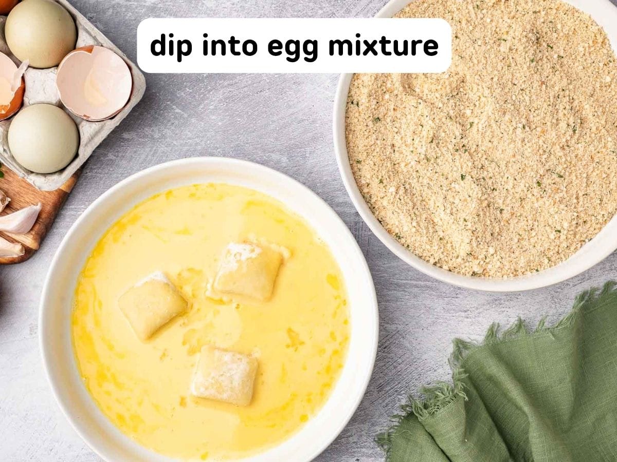 Dipping the raviolis into the egg mixture.