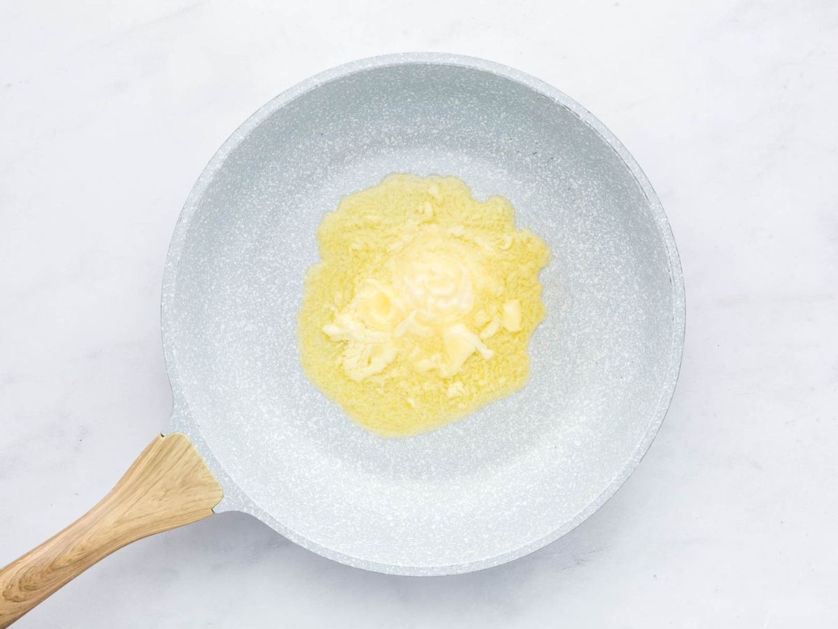 Butter melting in a skillet.