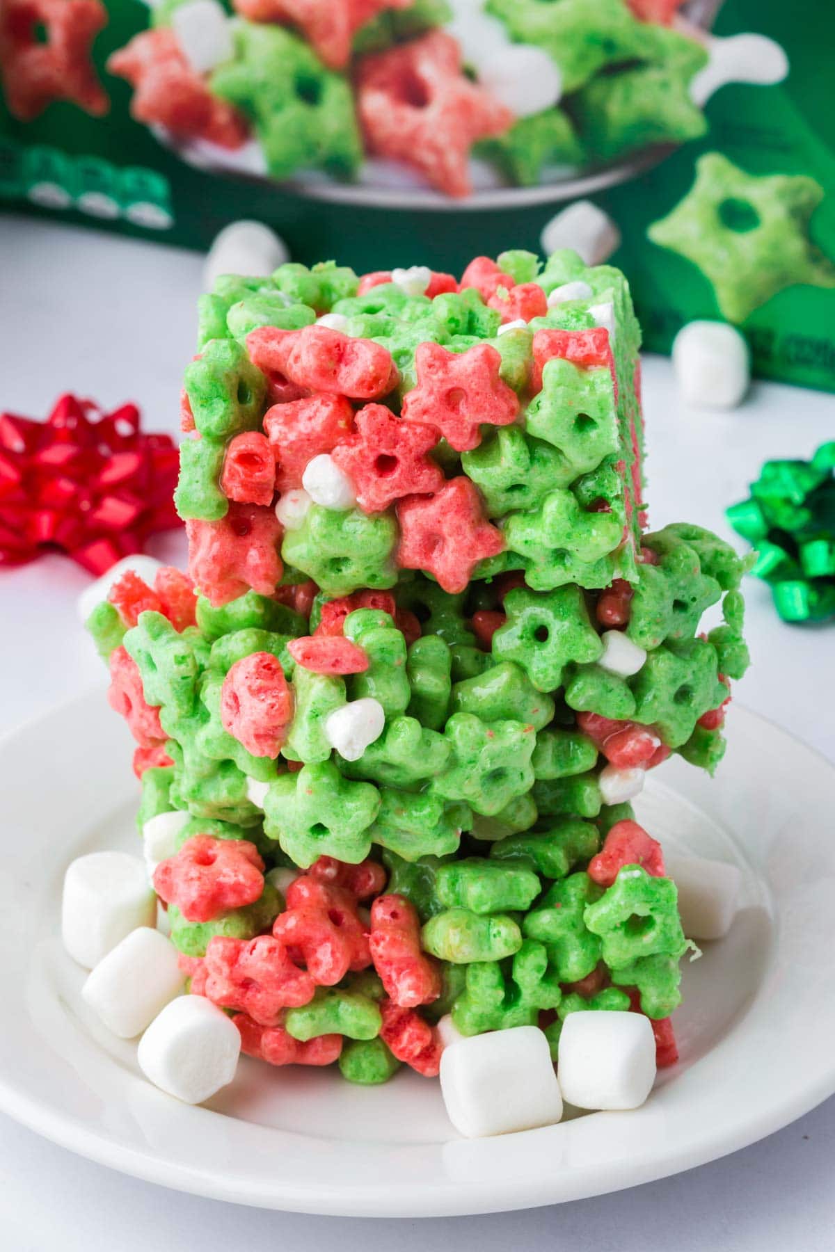 Three Elf on a Shelf cereal bars stacked on top of each other on a plate.