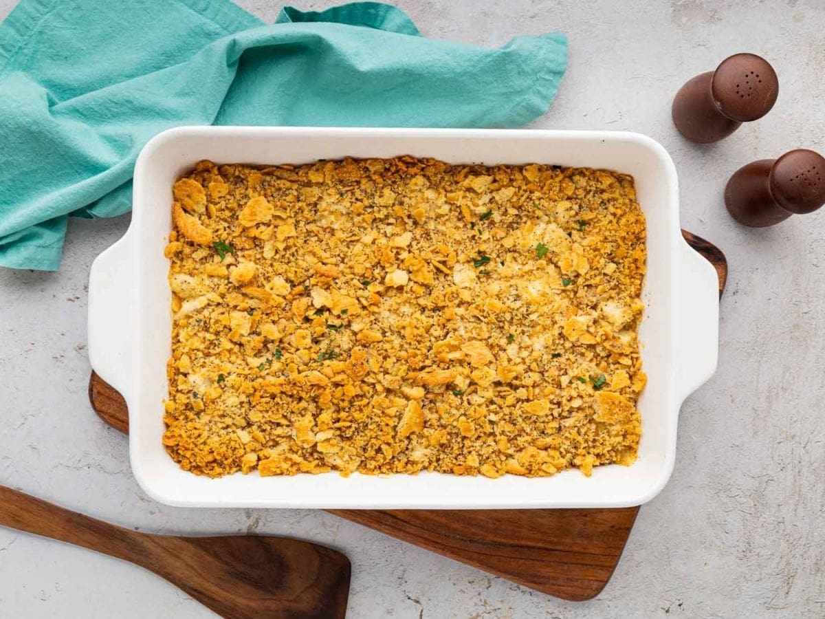 A baked poppy seed chicken casserole in a white casserole dish.