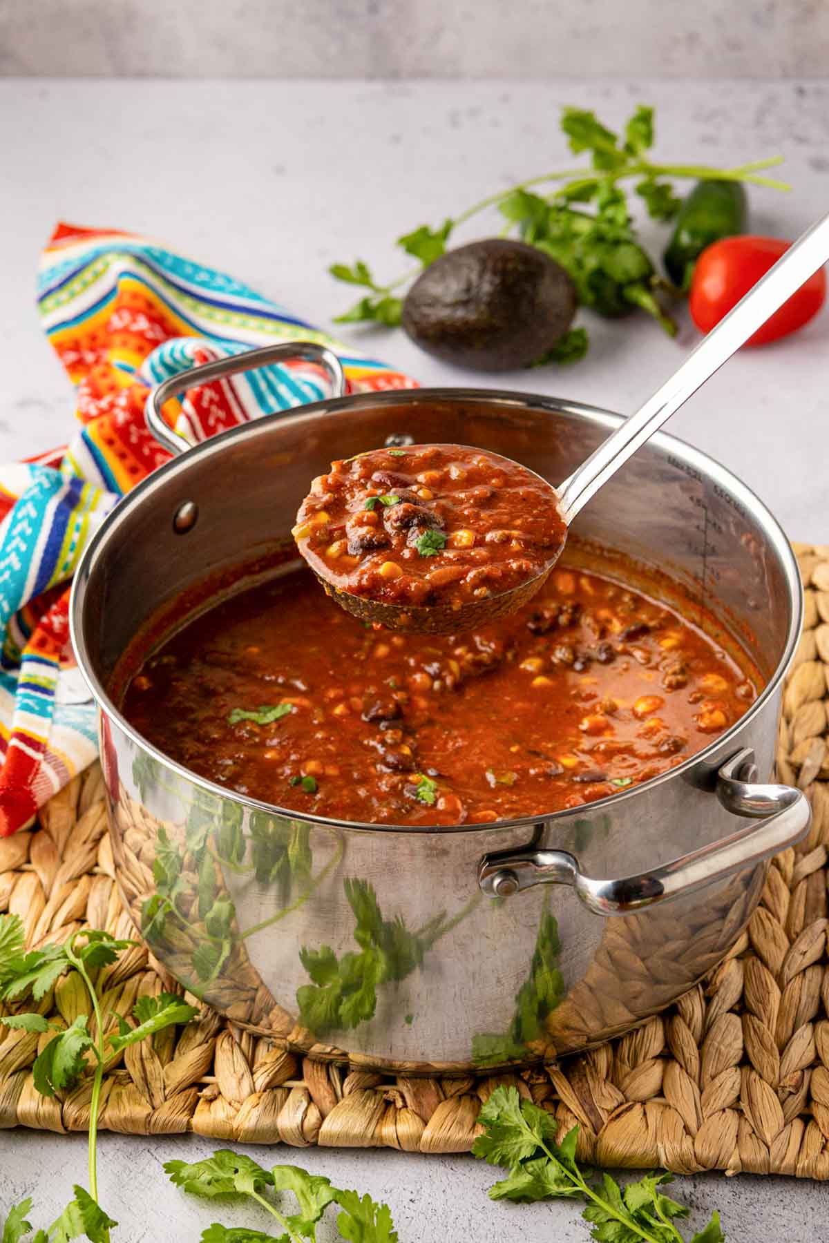 A large pot with taco soup and a ladle, removing a scoop of soup.