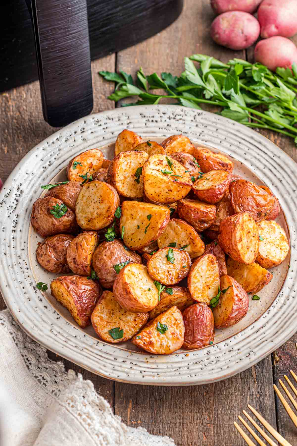 Air fryer roasted red potatoes on a serving plate.