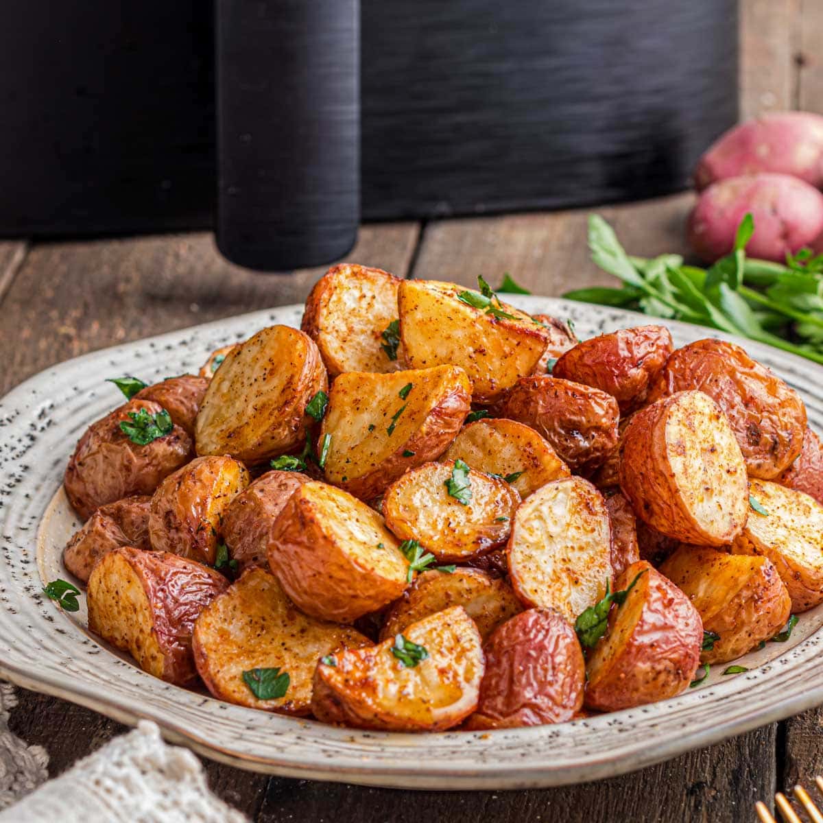 Air fryer baby potatoes on a serving plate.