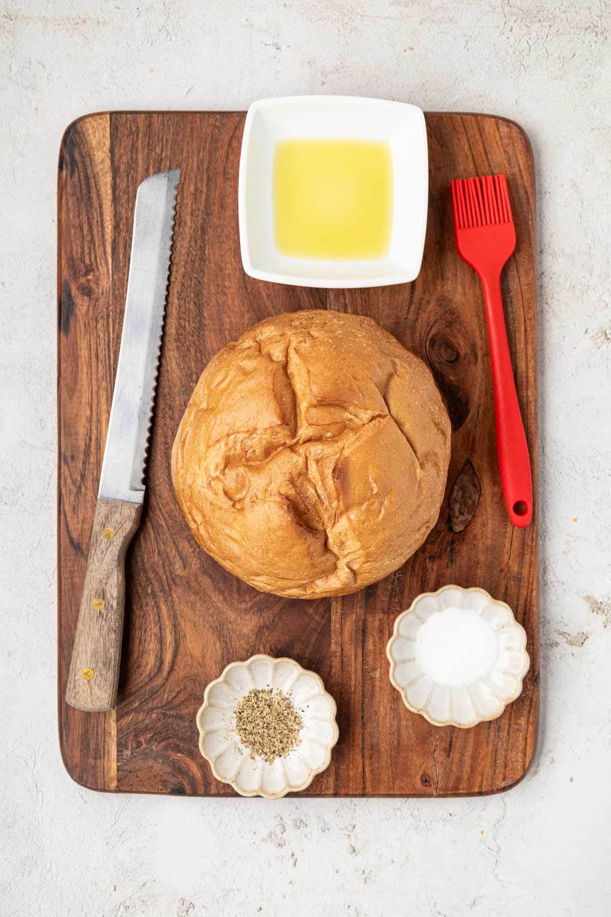 Ingredients for the bread bowl on a wooden board.